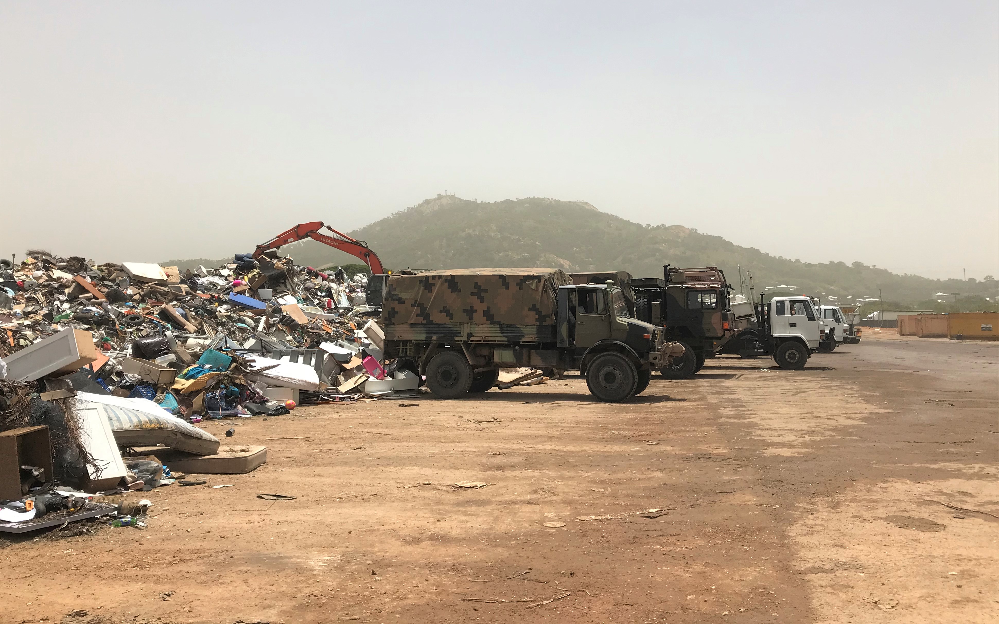 Photograph of army trucks clearing flood debris in Townsville, 2019. CC BY 4.0 Patrick White.